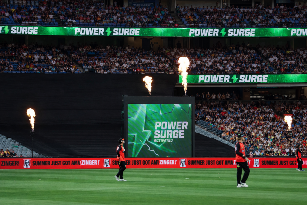 BBL Power Surge Runs Predictor scene as Power Surge is activated in a Big Bash League match with players on the field and stadium graphics